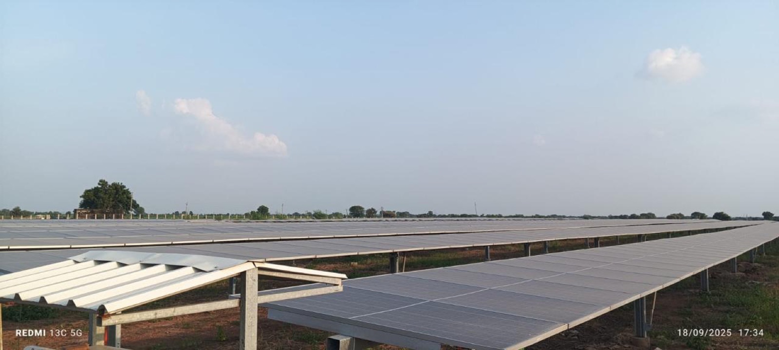 A foreground module table leading the eye into the wider ground-mount array.