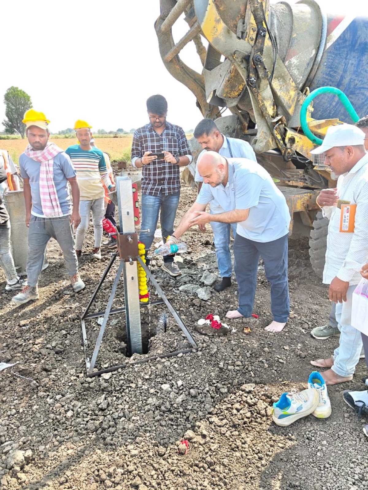 Team members setting the ceremonial first pile foundation at a new solar site.