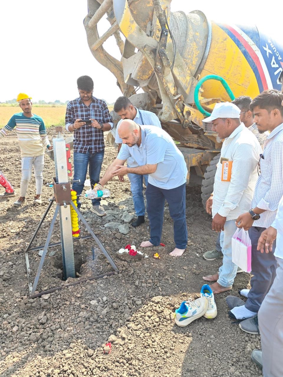 The crew gathered around the first foundation during the groundbreaking ceremony.